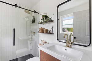 Bathroom with a shower stall and vanity