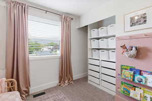 Playroom with baseboards and light carpet