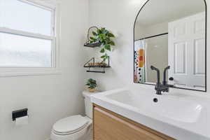 Full bath with vanity and curtained shower