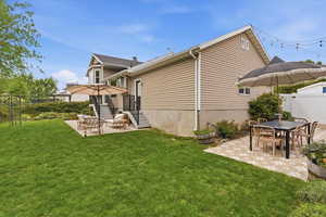Rear view of property with a patio and outdoor dining space