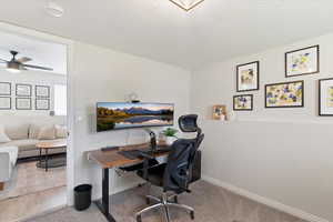Office space featuring a textured ceiling and ceiling fan