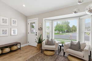 Sitting room featuring wood finished floors and lofted ceiling