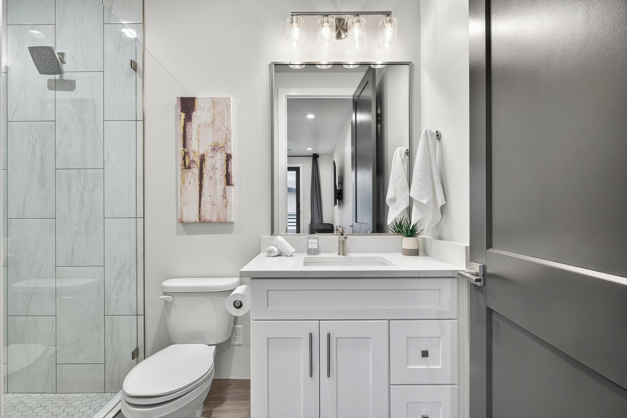 Full bathroom with vanity and a stall shower
