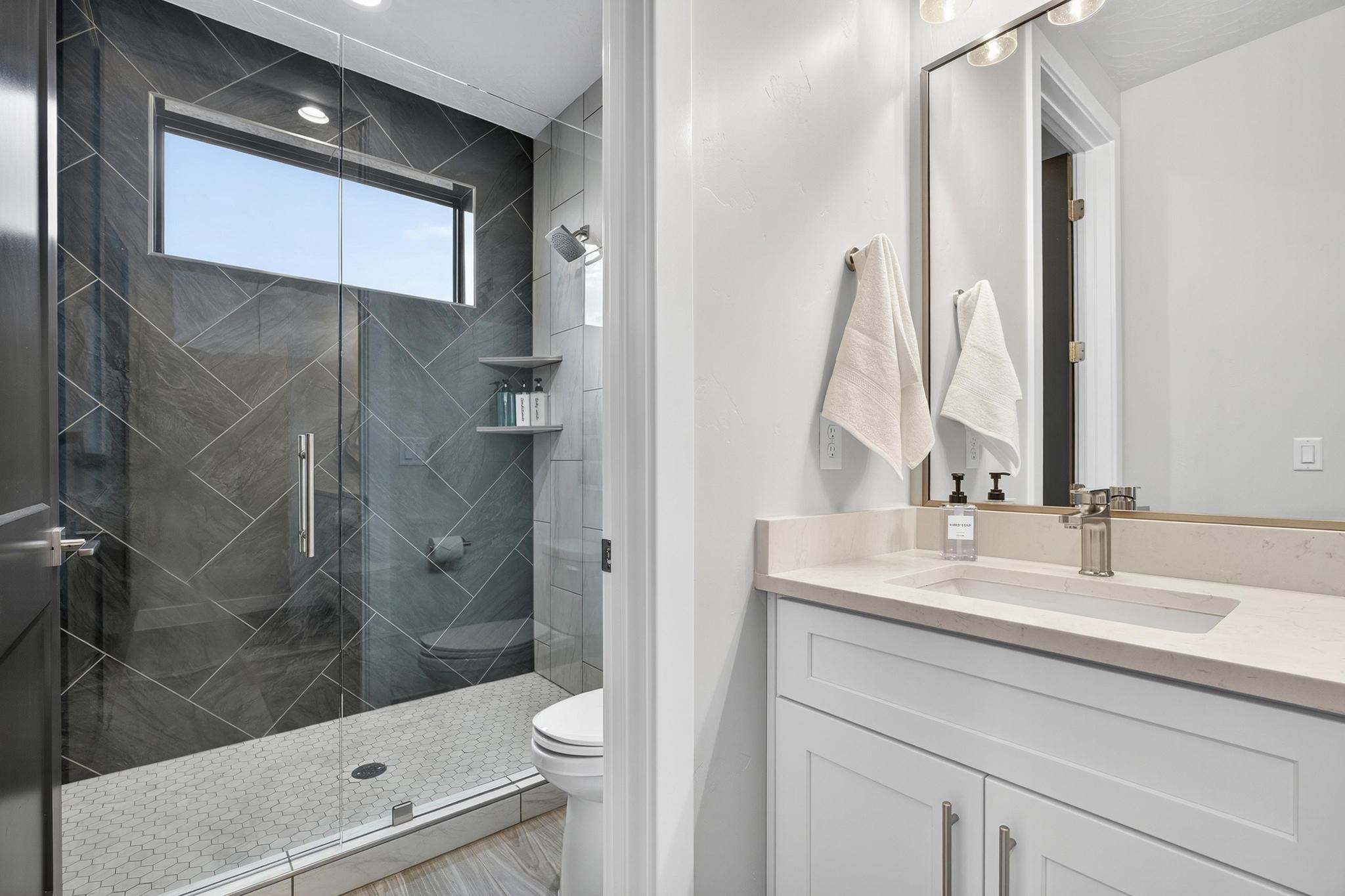 Full bath with vanity and a shower stall
