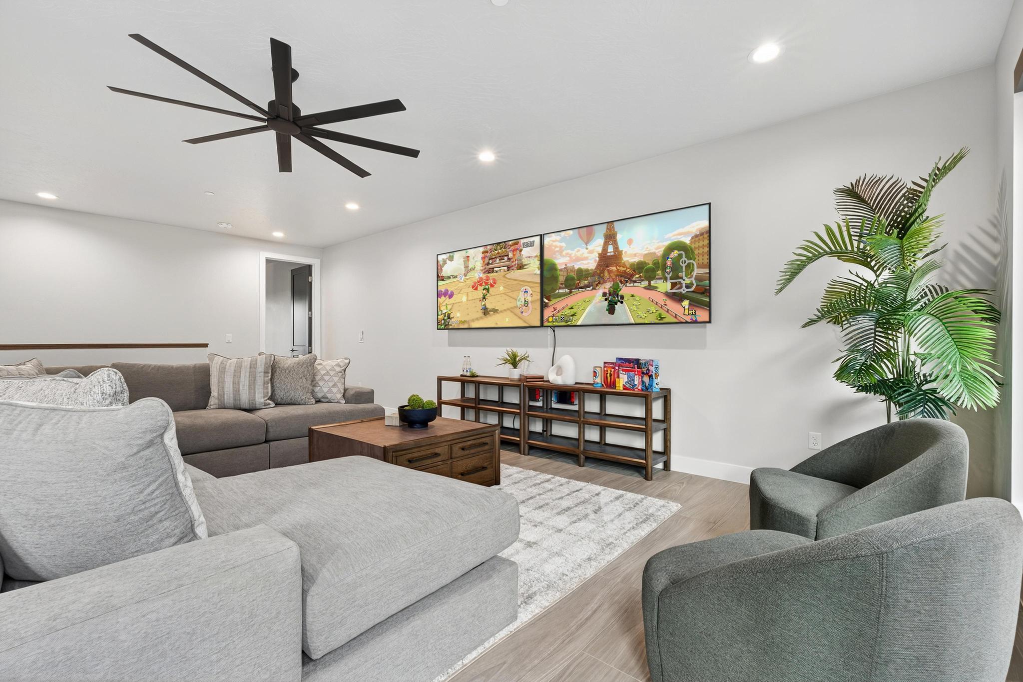 Living area featuring wood finished floors, a ceiling fan, and recessed lighting