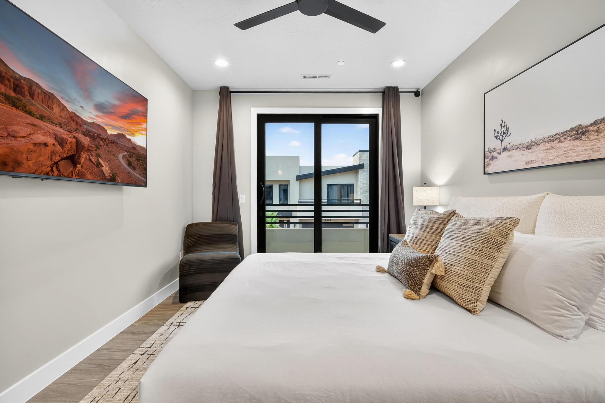 Bedroom with light wood-style flooring, access to outside, and a ceiling fan