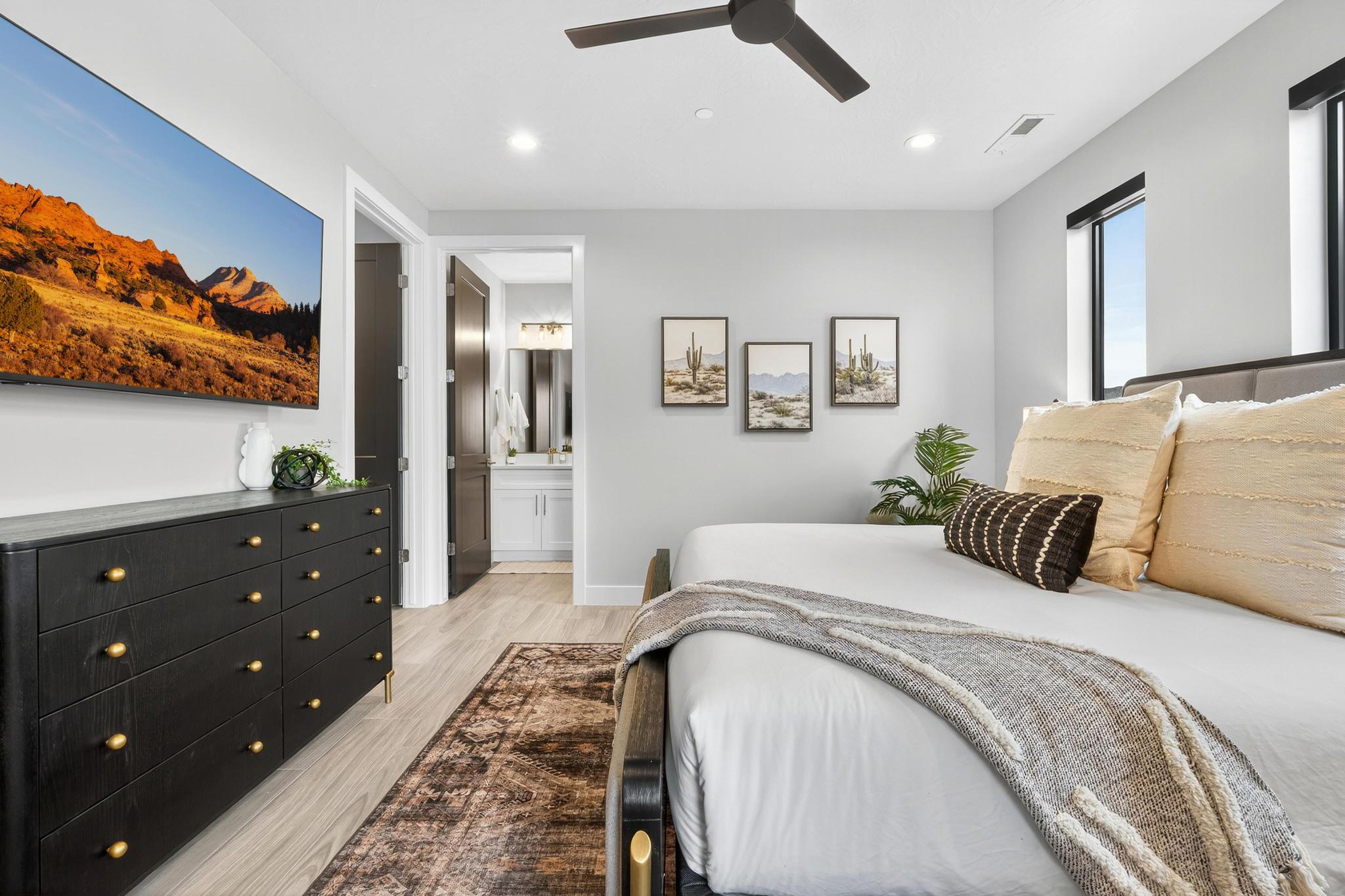 Bedroom with light wood-style flooring, recessed lighting, ensuite bathroom, and ceiling fan