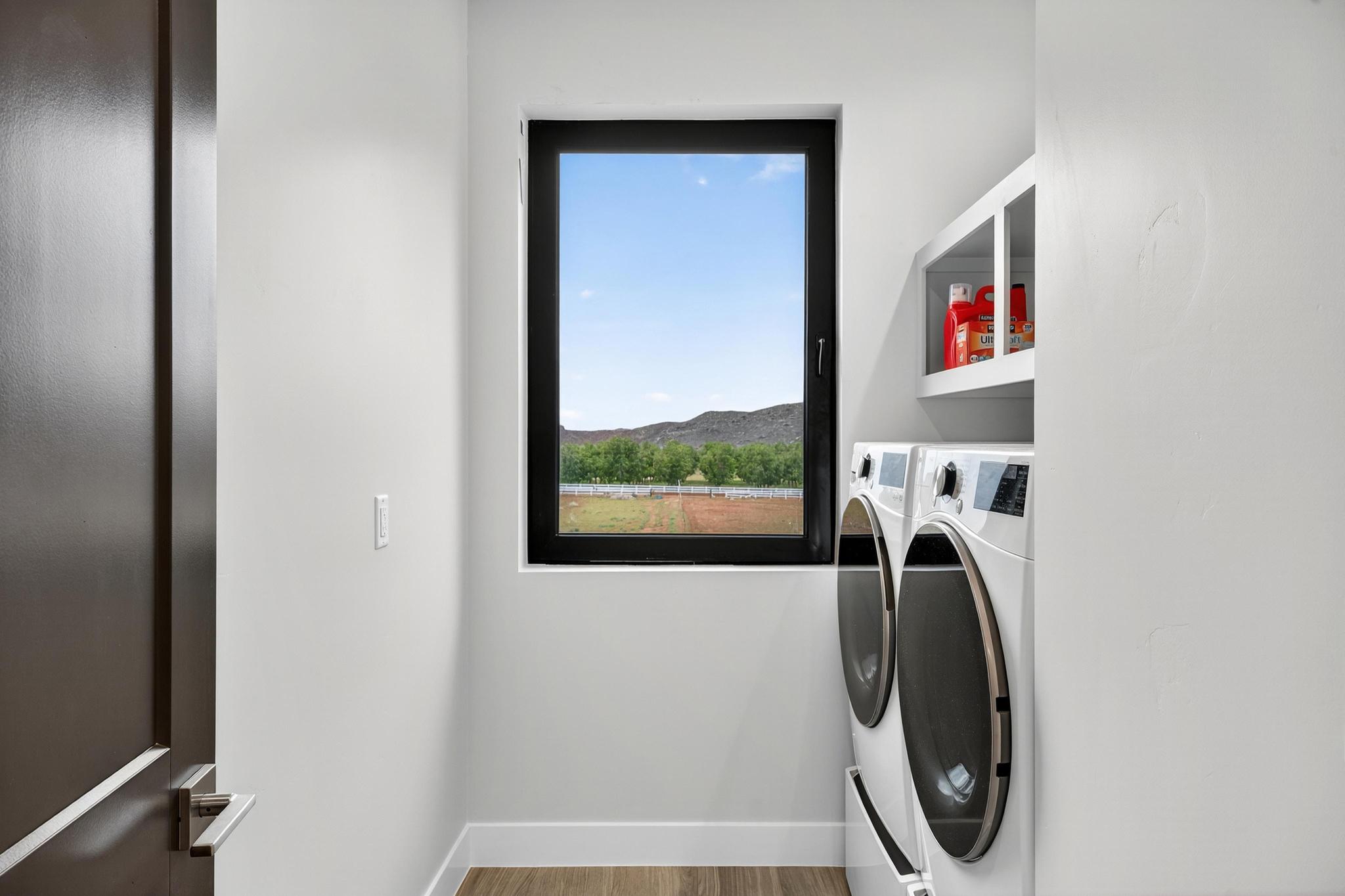 Laundry area featuring separate washer and dryer and light wood-style floors