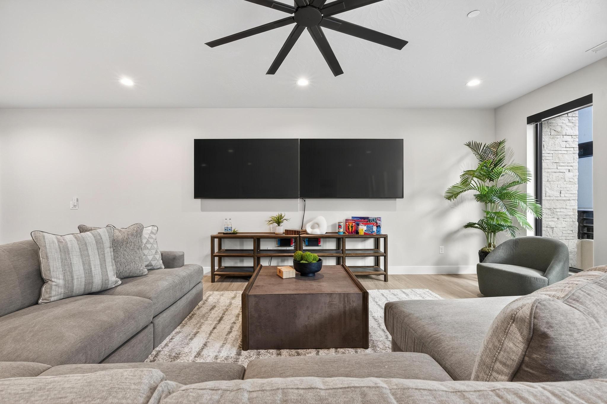 Living room featuring light wood-type flooring, ceiling fan, and recessed lighting