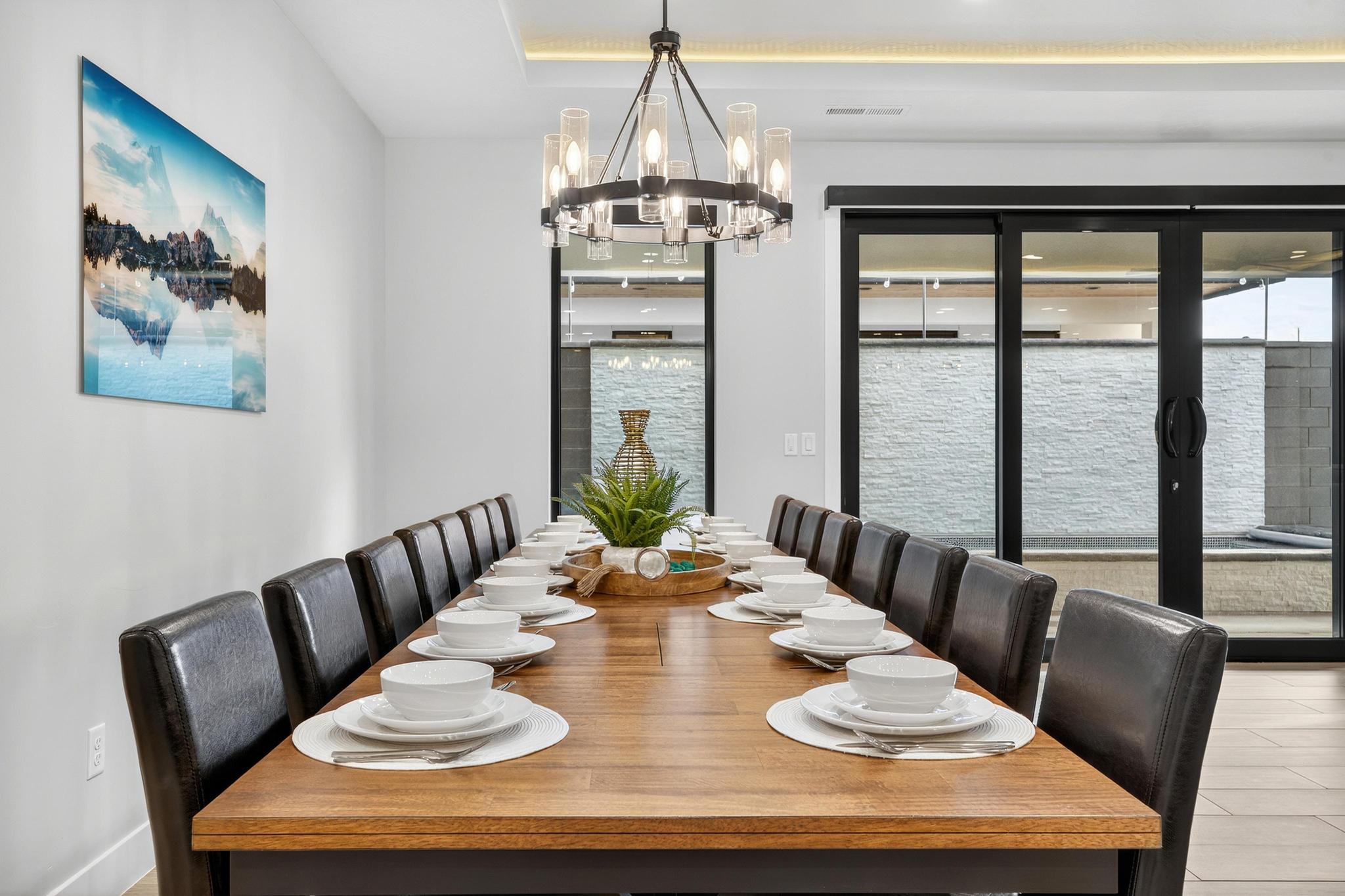 Dining space featuring suspended lighting, light wood-style floors, and a tray ceiling