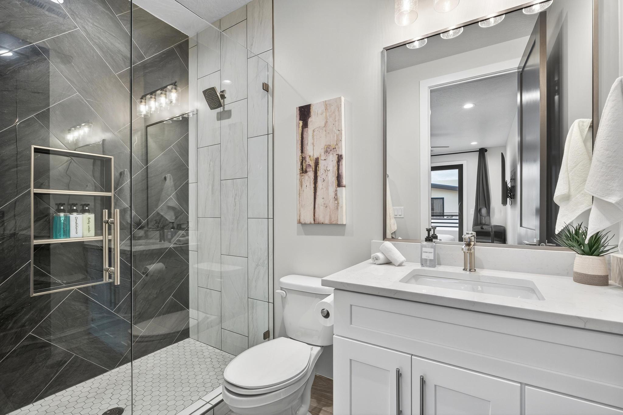 Full bathroom with vanity and a marble finish shower