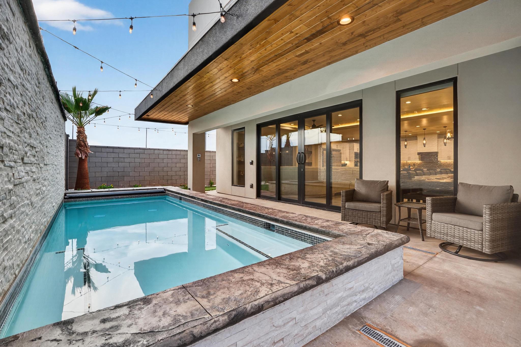View of swimming pool featuring patio surround, a fenced backyard, and french doors