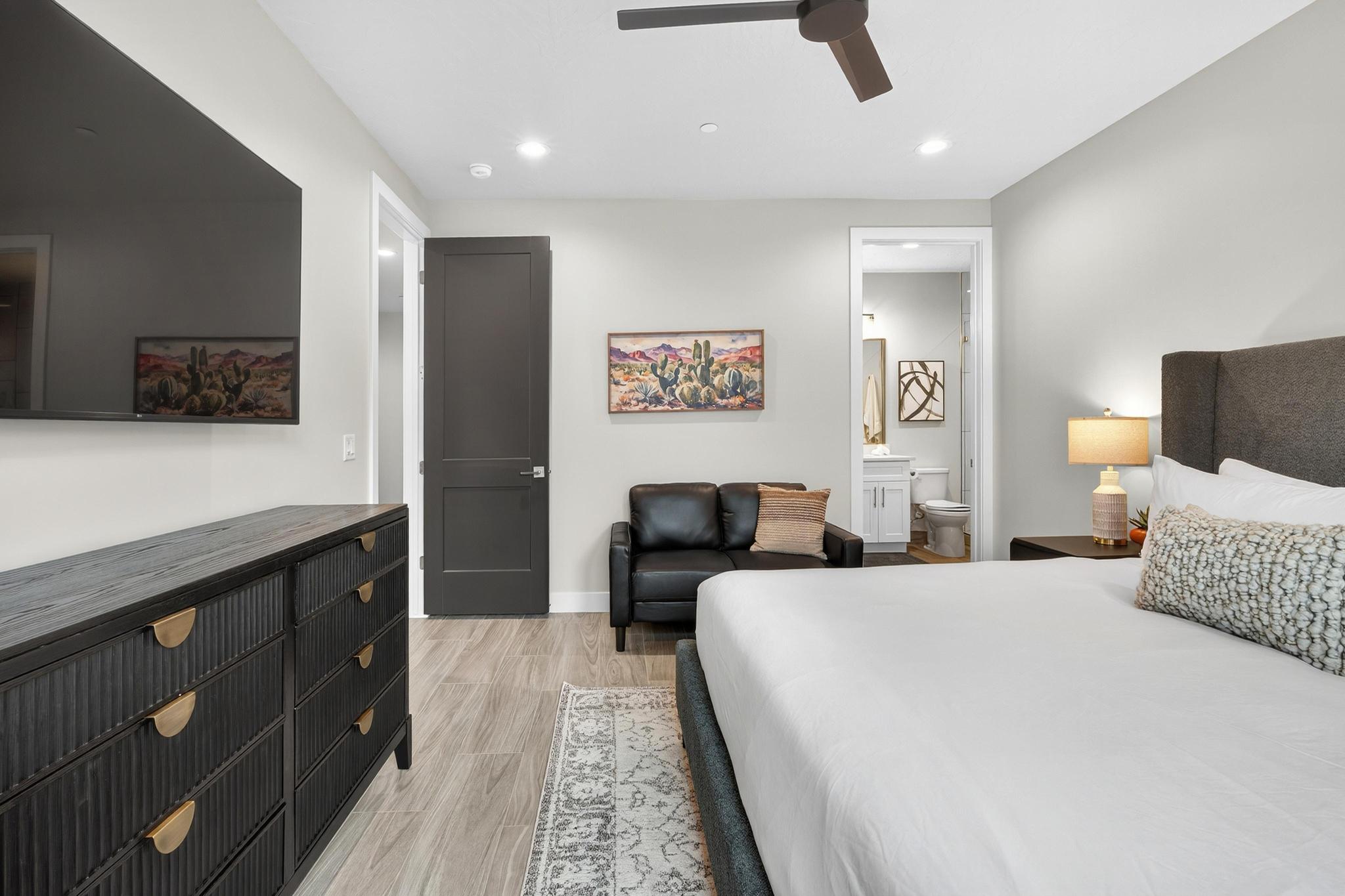 Bedroom featuring ceiling fan, ensuite bath, light wood finished floors, and recessed lighting