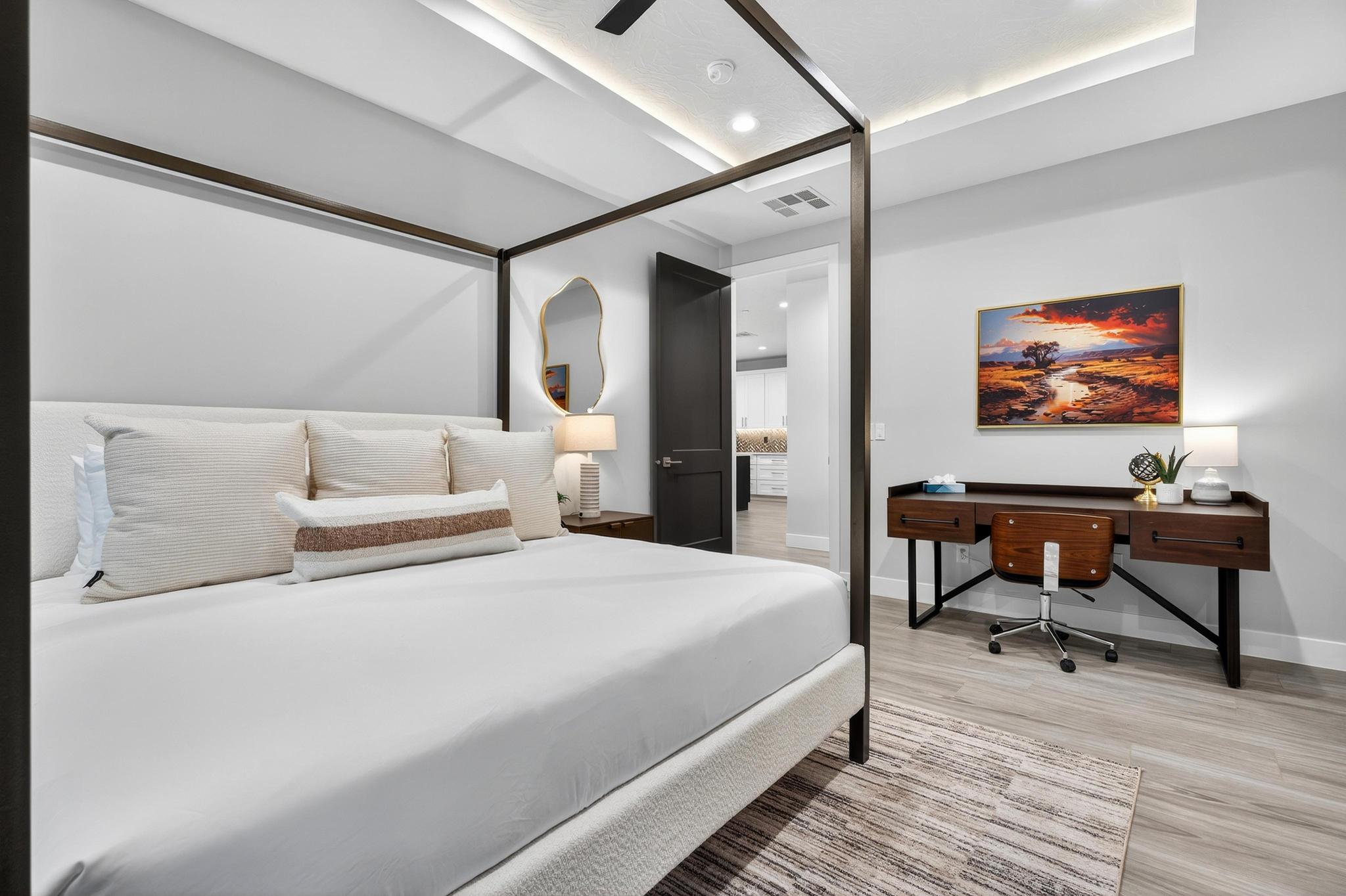 Bedroom with light wood finished floors, a ceiling fan, recessed lighting, and an office area