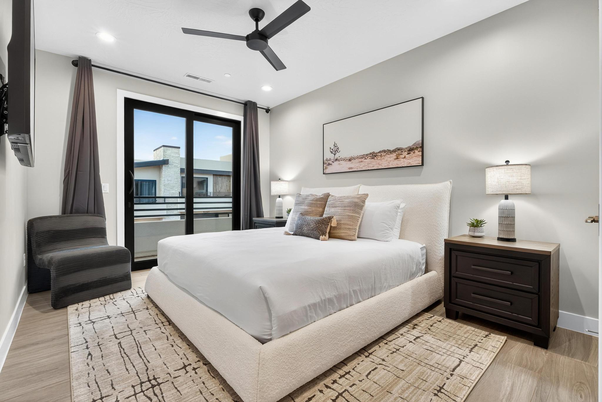 Bedroom with access to exterior, a ceiling fan, and light wood-type flooring