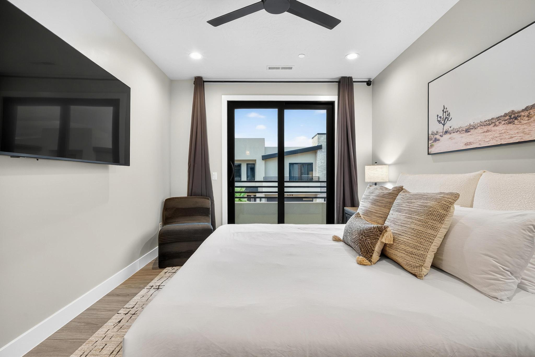 Bedroom with wood finished floors, access to exterior, and ceiling fan