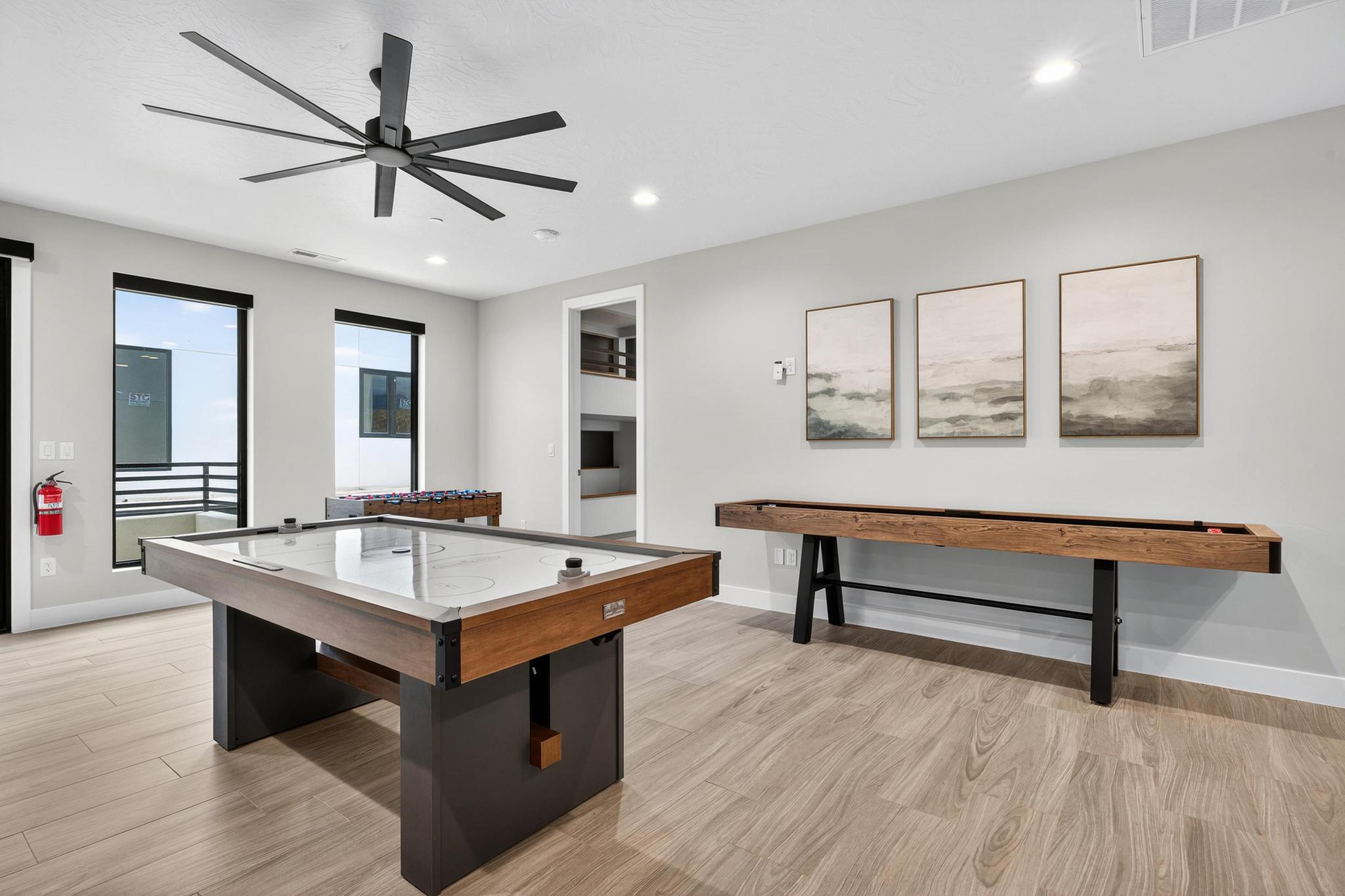 Playroom with light wood-style floors, a ceiling fan, and recessed lighting