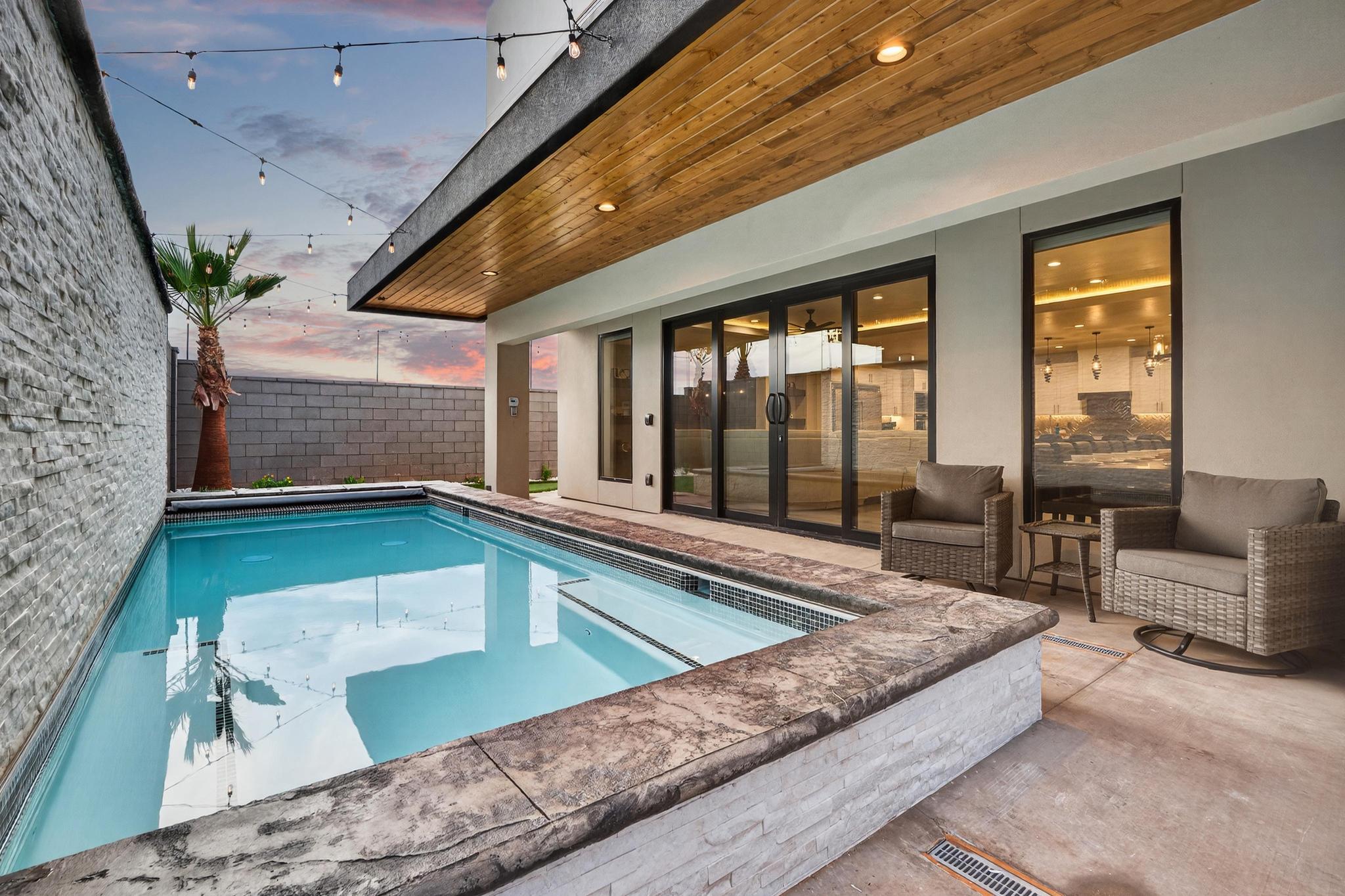 View of swimming pool with patio surround, a fenced backyard, and french doors