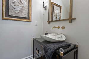 Two guest half baths are each unique and clever fixtures.