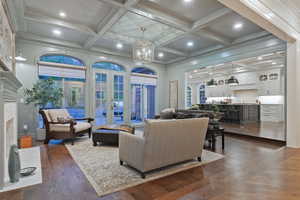 Charming family room off of kitchen w/coffered ceiling, French doors, and a cozy fireplace