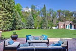 Breathtaking private backyard with towering pines and mature trees.