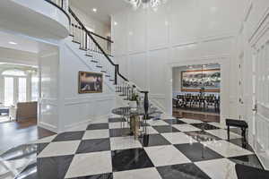 Unique and elegant foyer opens to the stunning formal dining room.