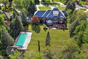 Aerial view of property and surrounding area with a pool, pool house and privacy!