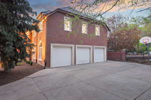 3 car oversized side-entry garage and large courtyard with basketball standard.
