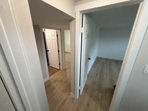 Hall featuring light wood-type flooring and baseboards