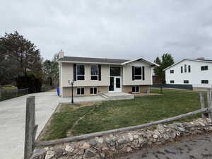 Split foyer home with brick siding and a chimney