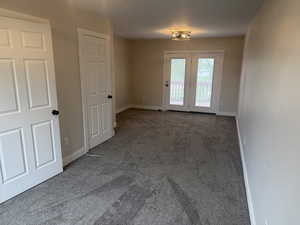Unfurnished room featuring carpet floors and baseboards