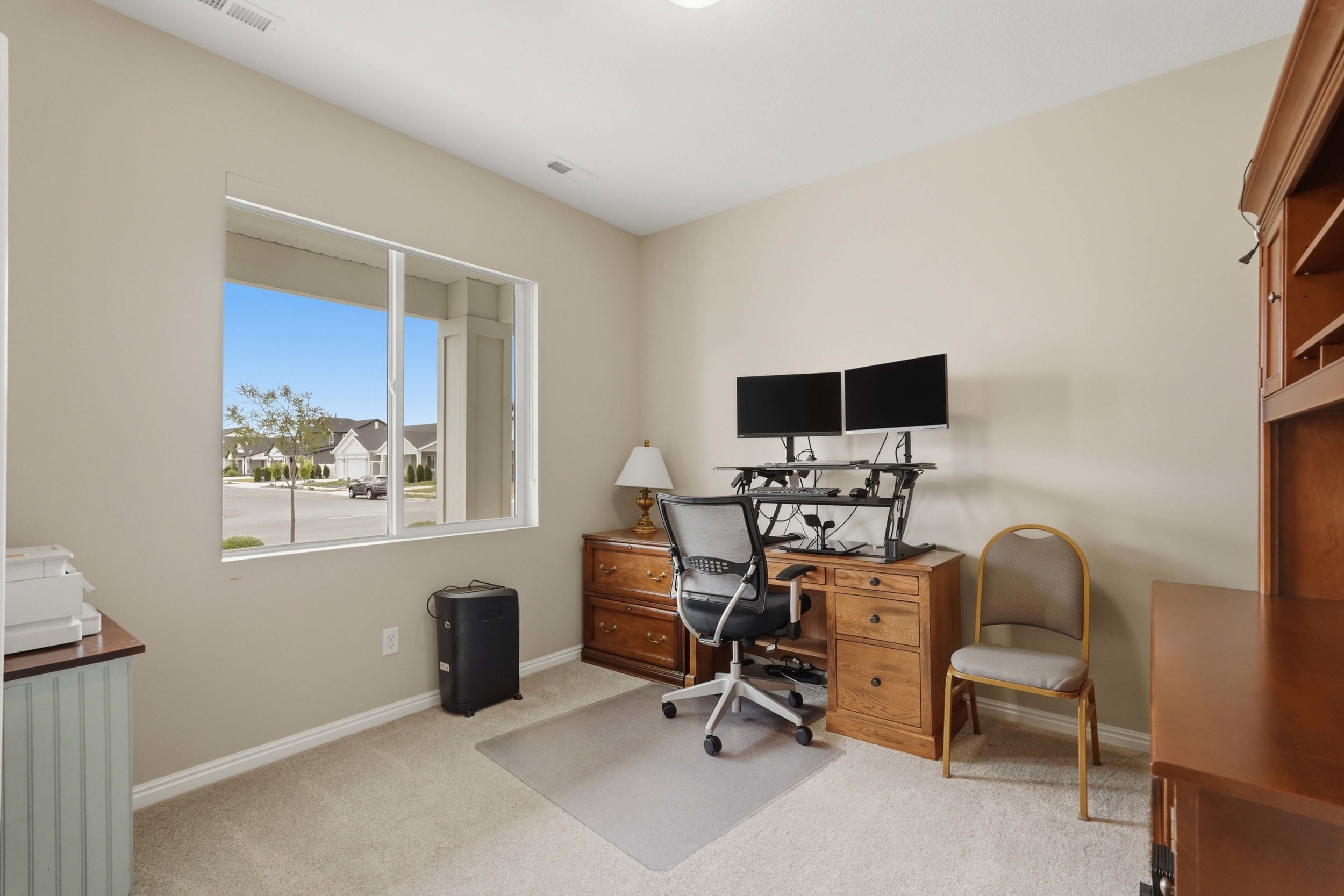 Office space with light carpet and baseboards