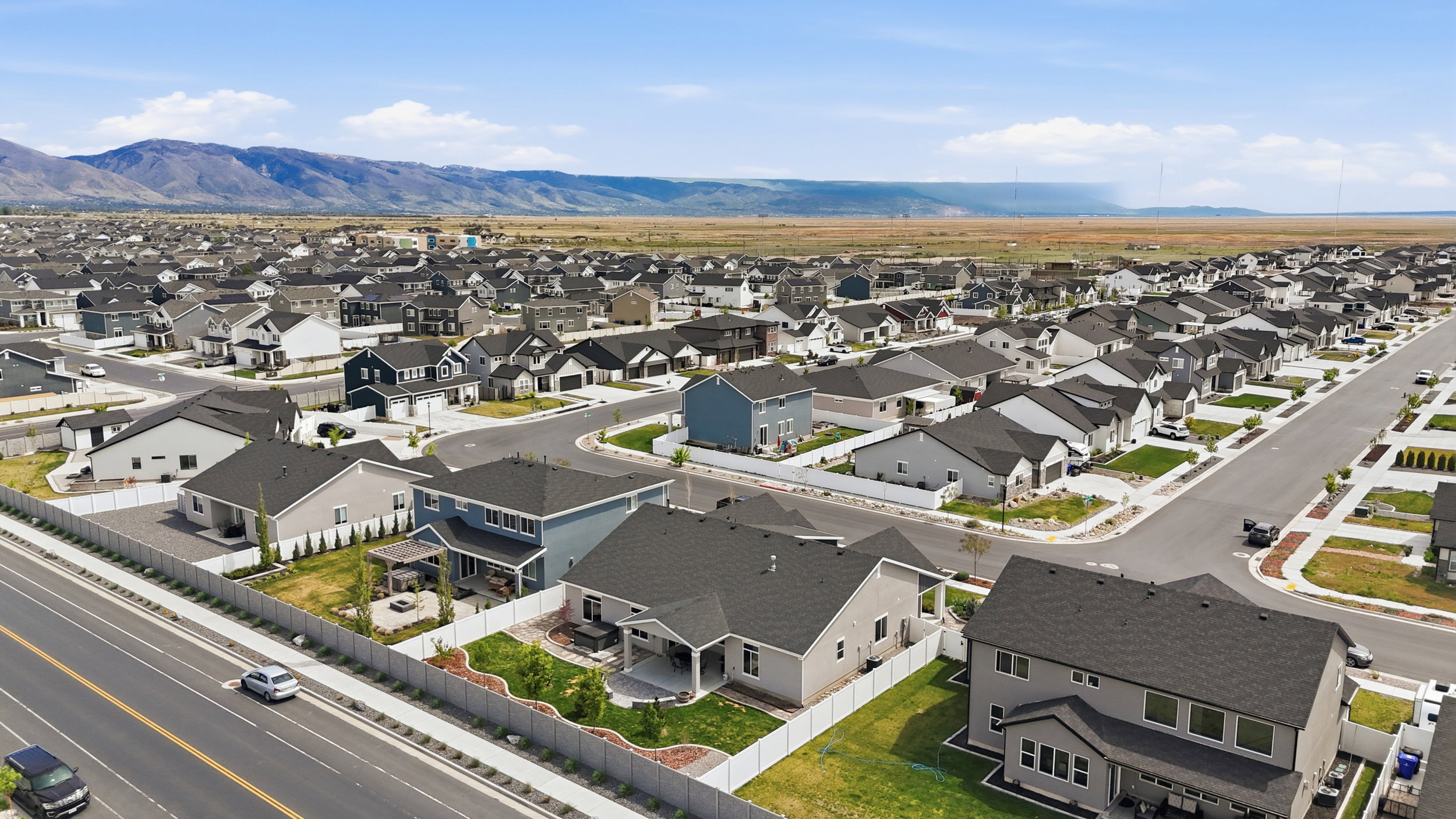 Aerial view of residential area featuring a mountainous background