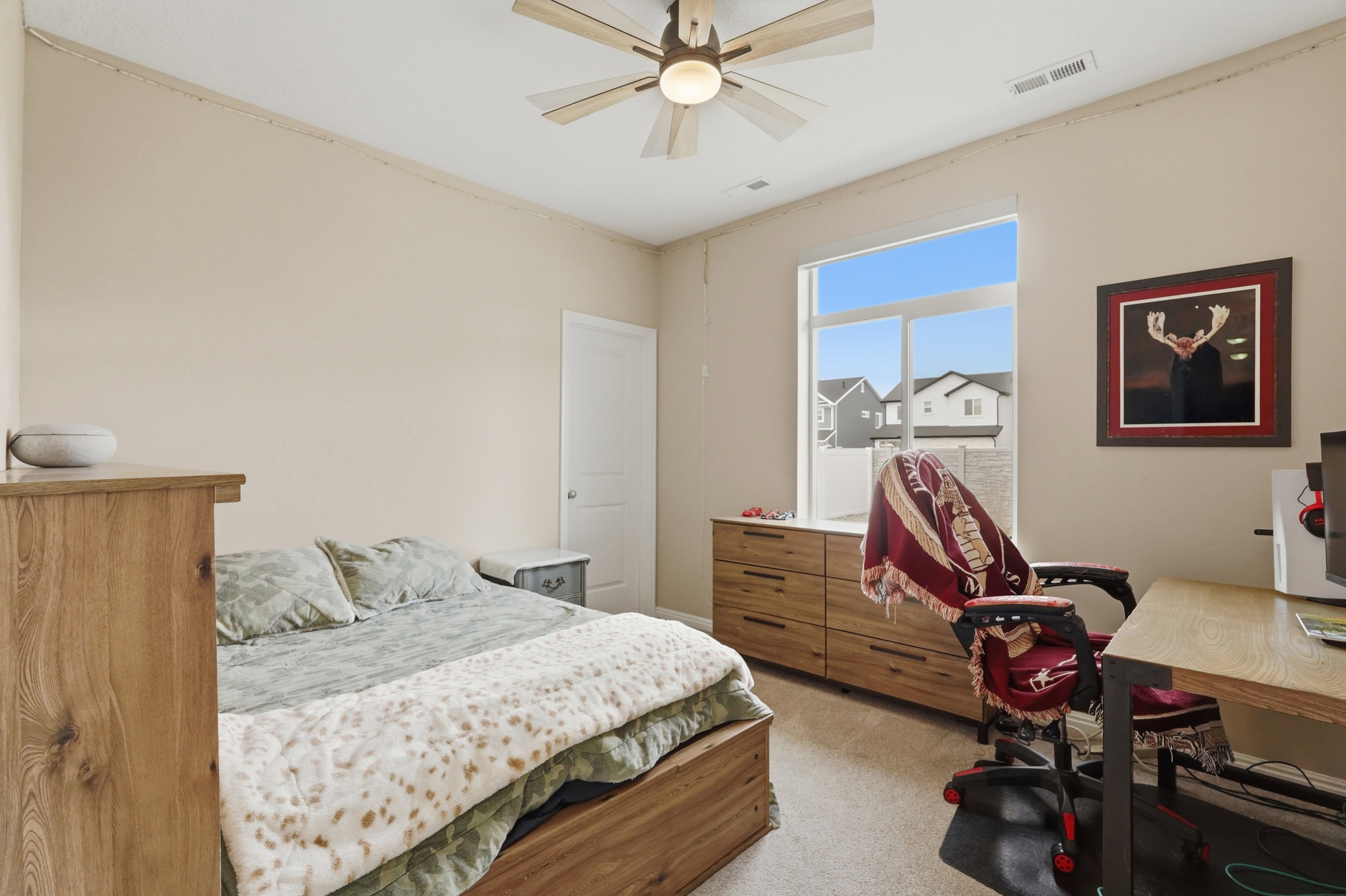 Bedroom with light carpet and ceiling fan