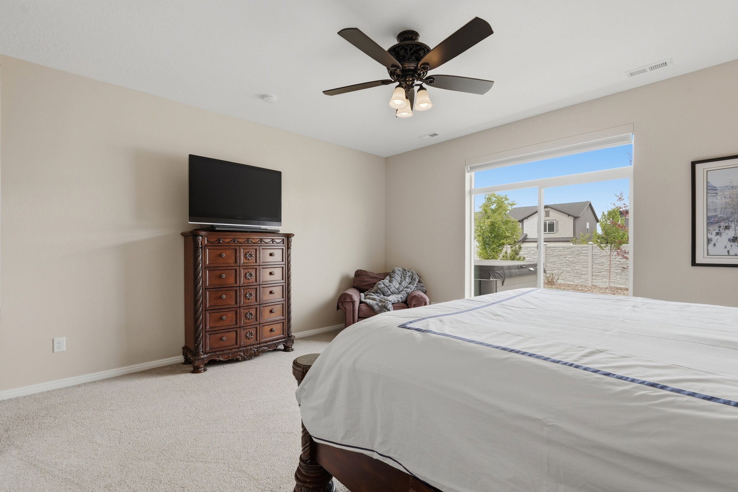 Carpeted bedroom featuring access to exterior and ceiling fan