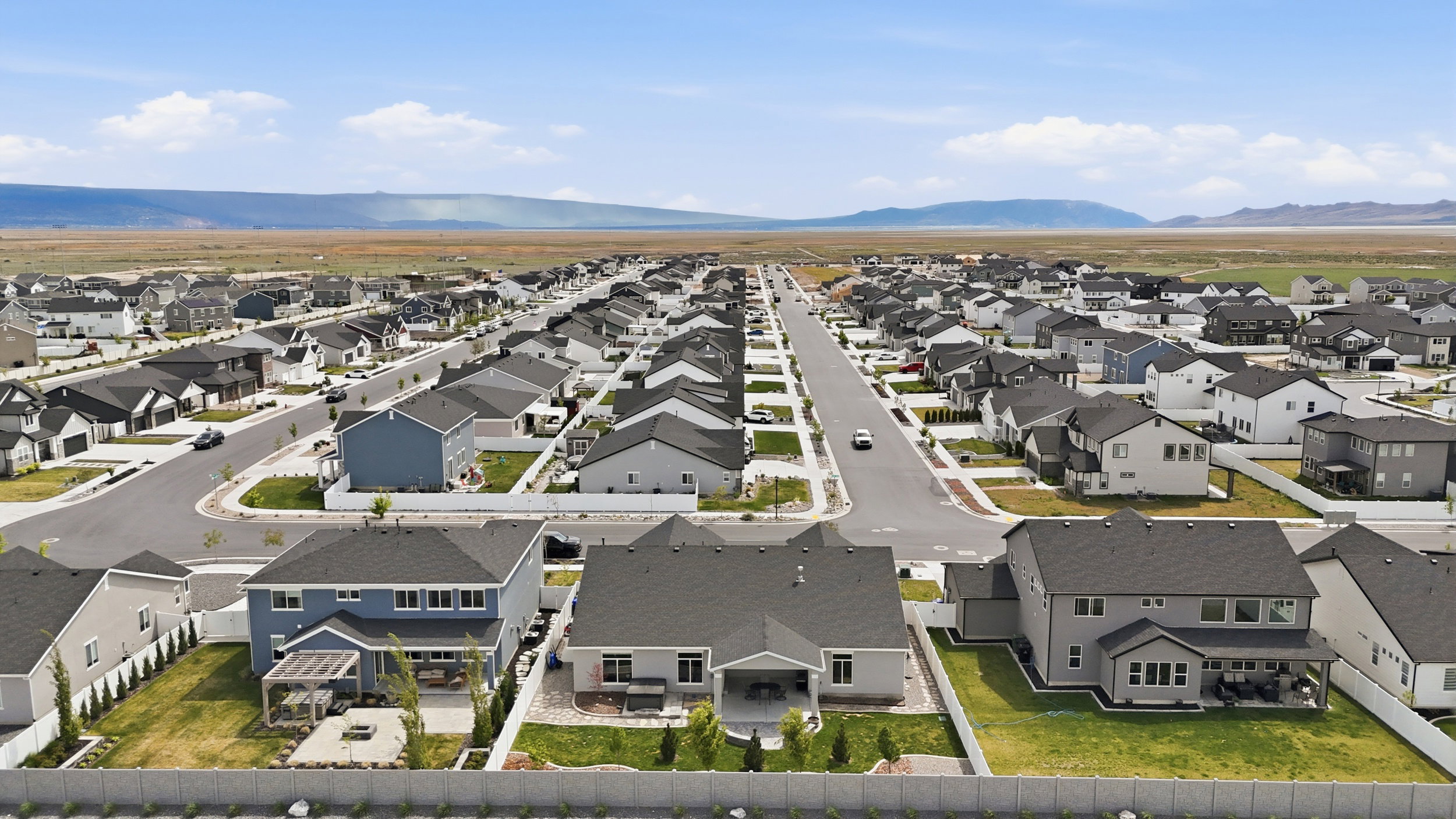 Aerial perspective of suburban area with a mountainous background