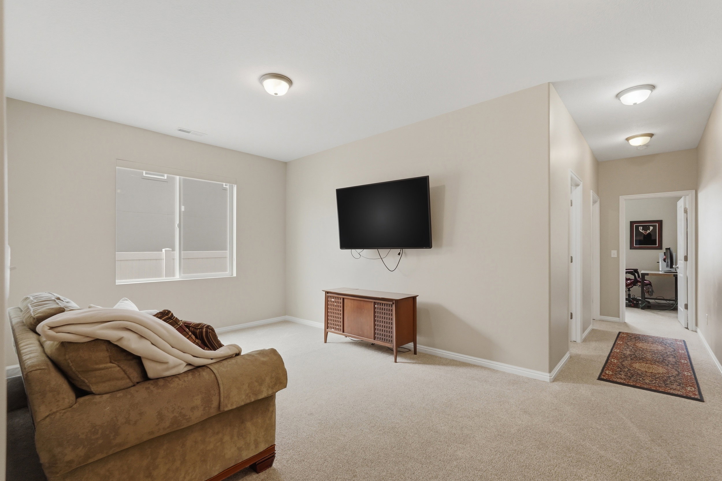 Living room with light carpet and baseboards