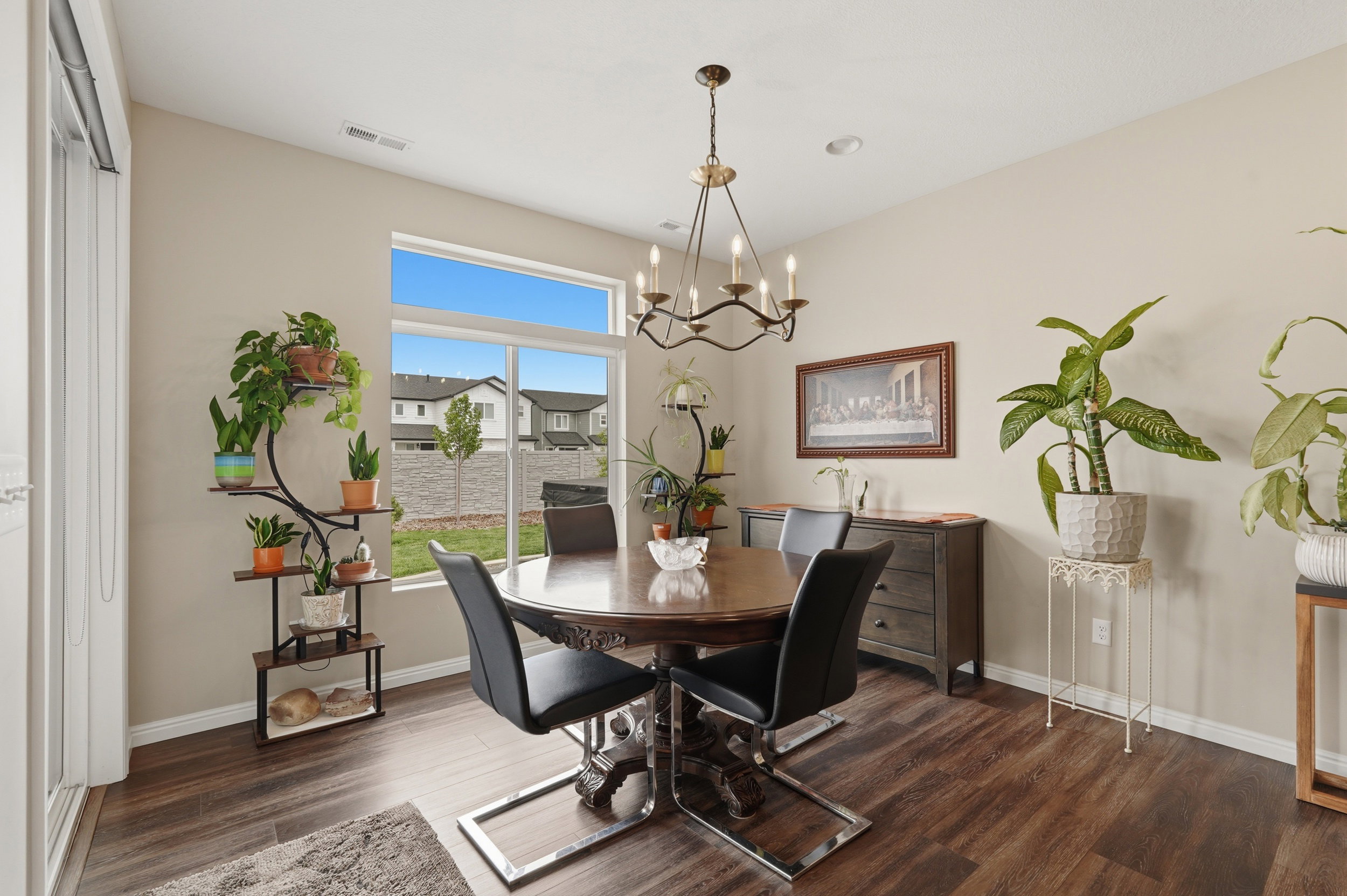Dining room with suspended lighting and dark wood-style flooring