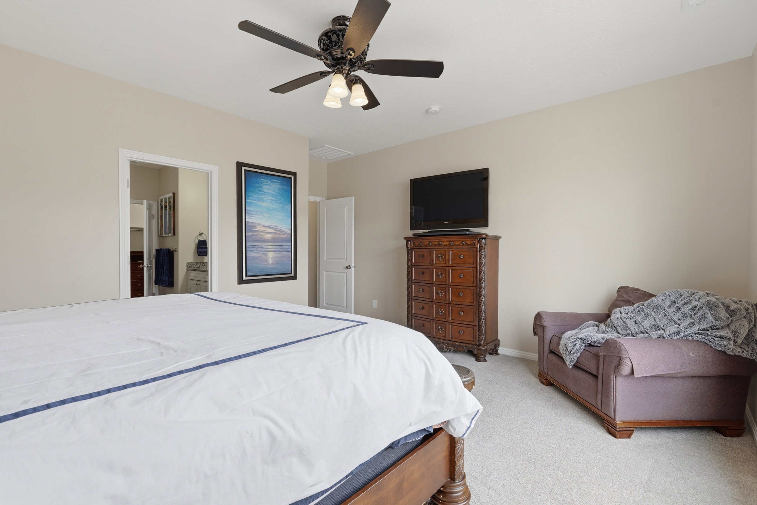 Bedroom featuring light carpet and a ceiling fan