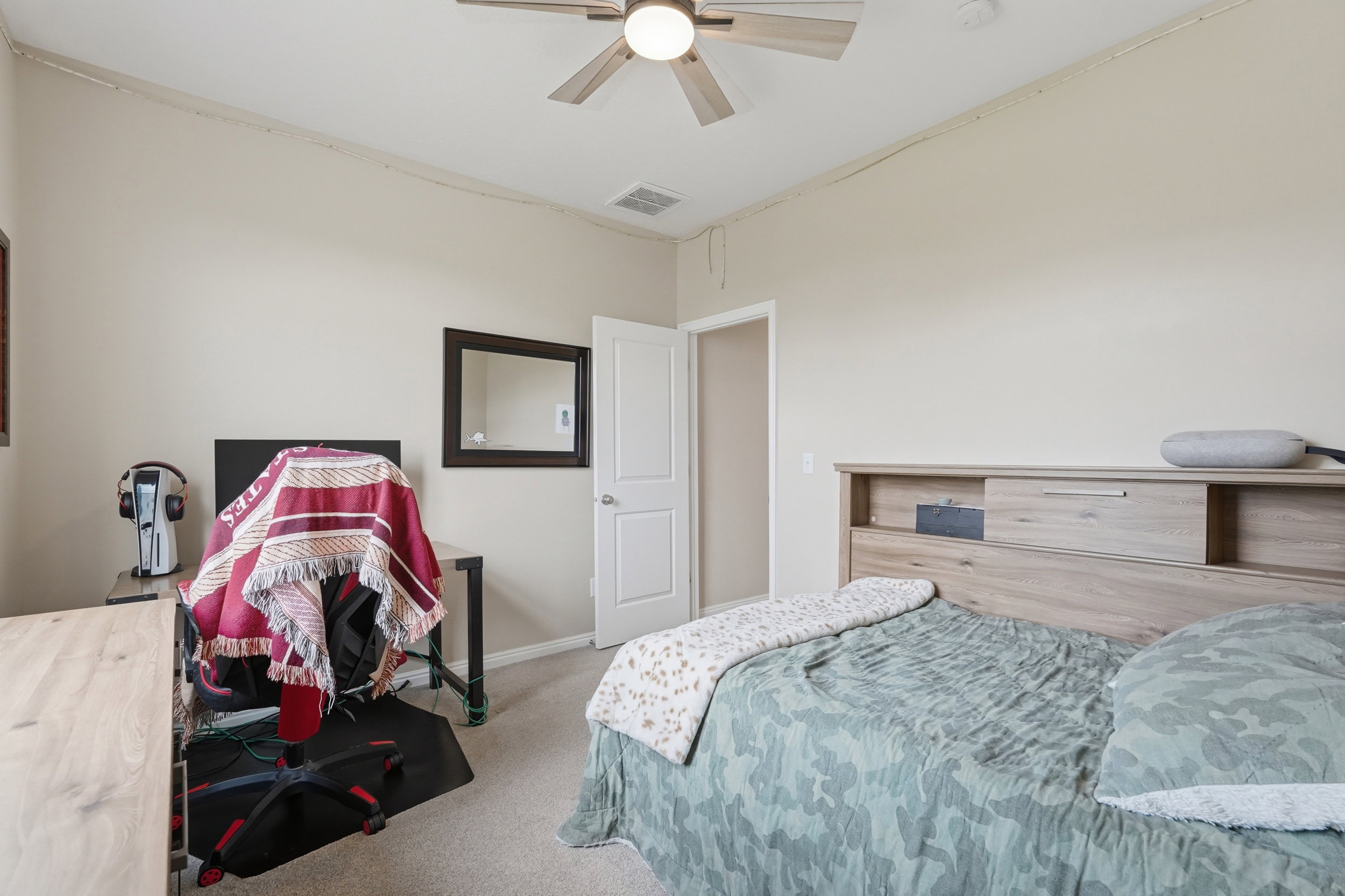 Bedroom featuring light colored carpet and a ceiling fan
