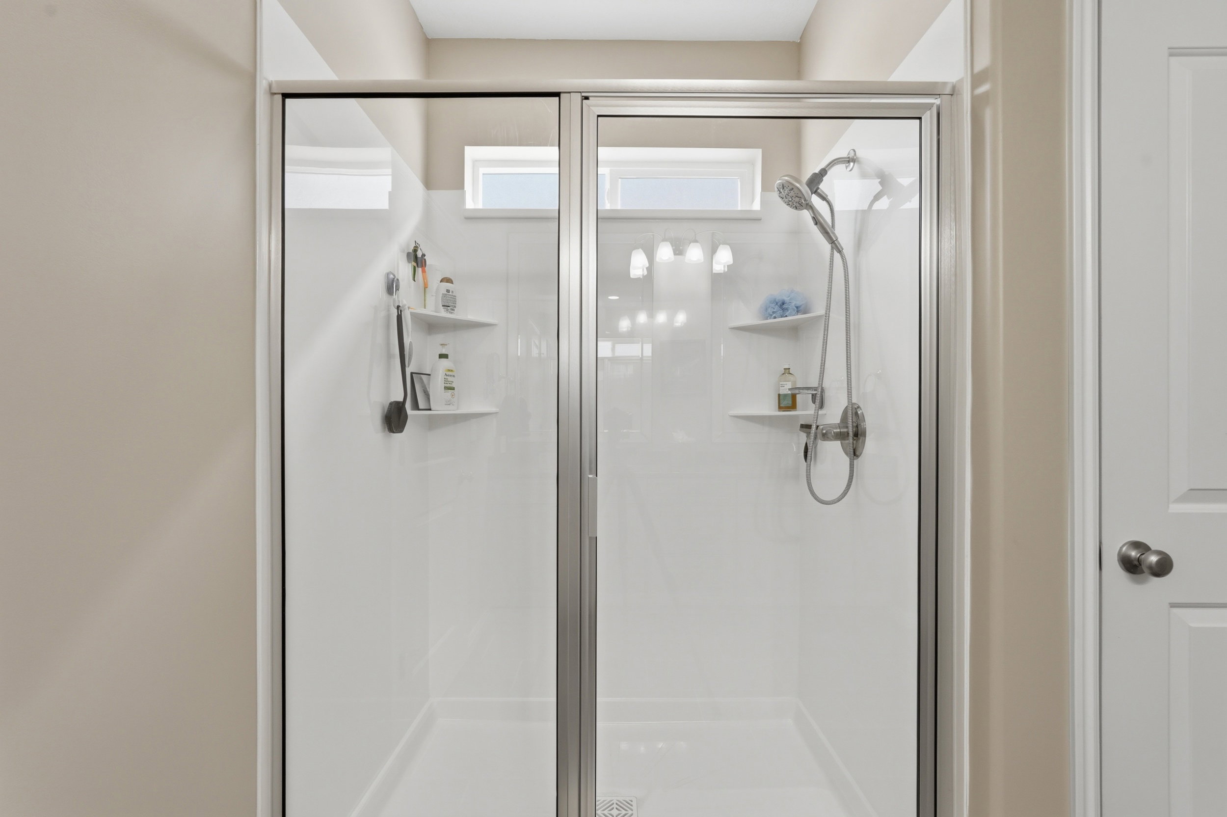 Full bath featuring a shower stall