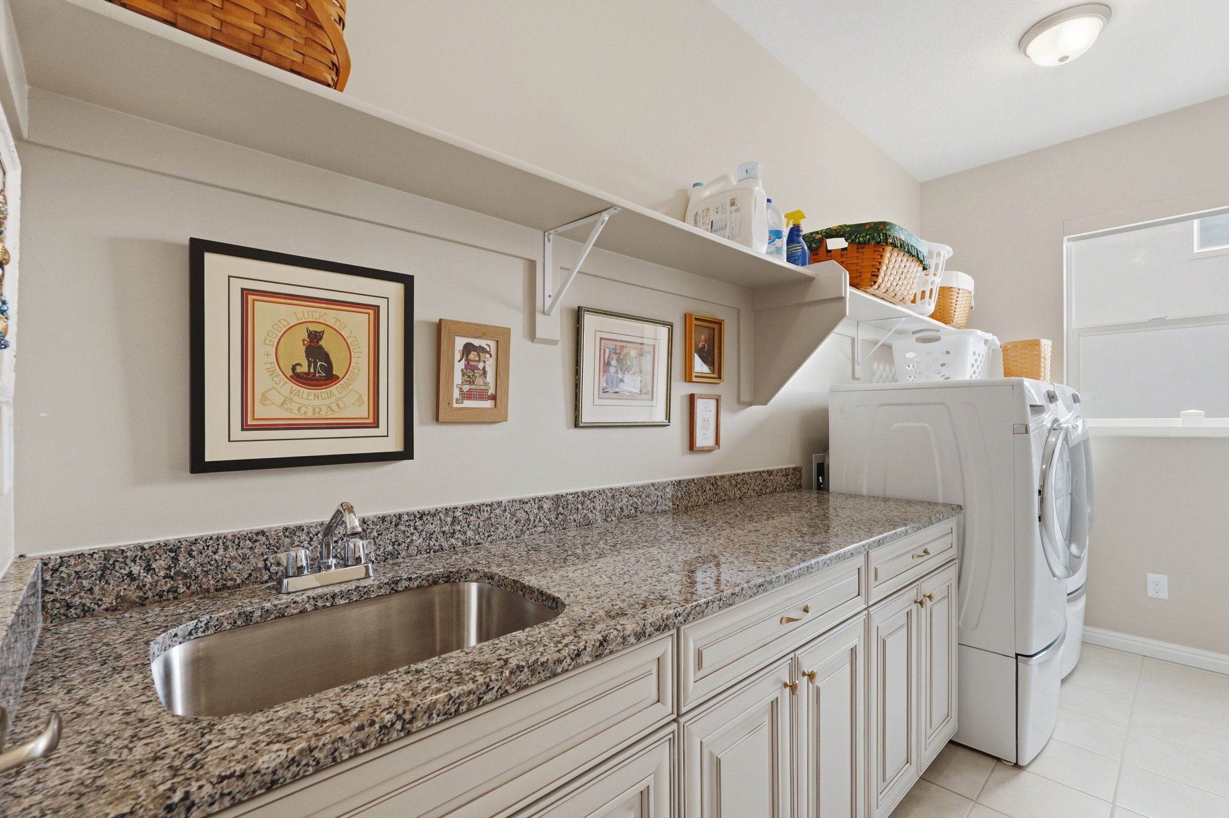 Laundry area featuring cabinet space, washer and dryer, and light tile patterned floors