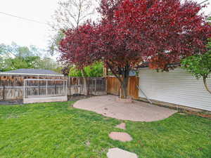 Fenced backyard with a patio area