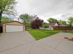 Fenced backyard with an outbuilding and a garage