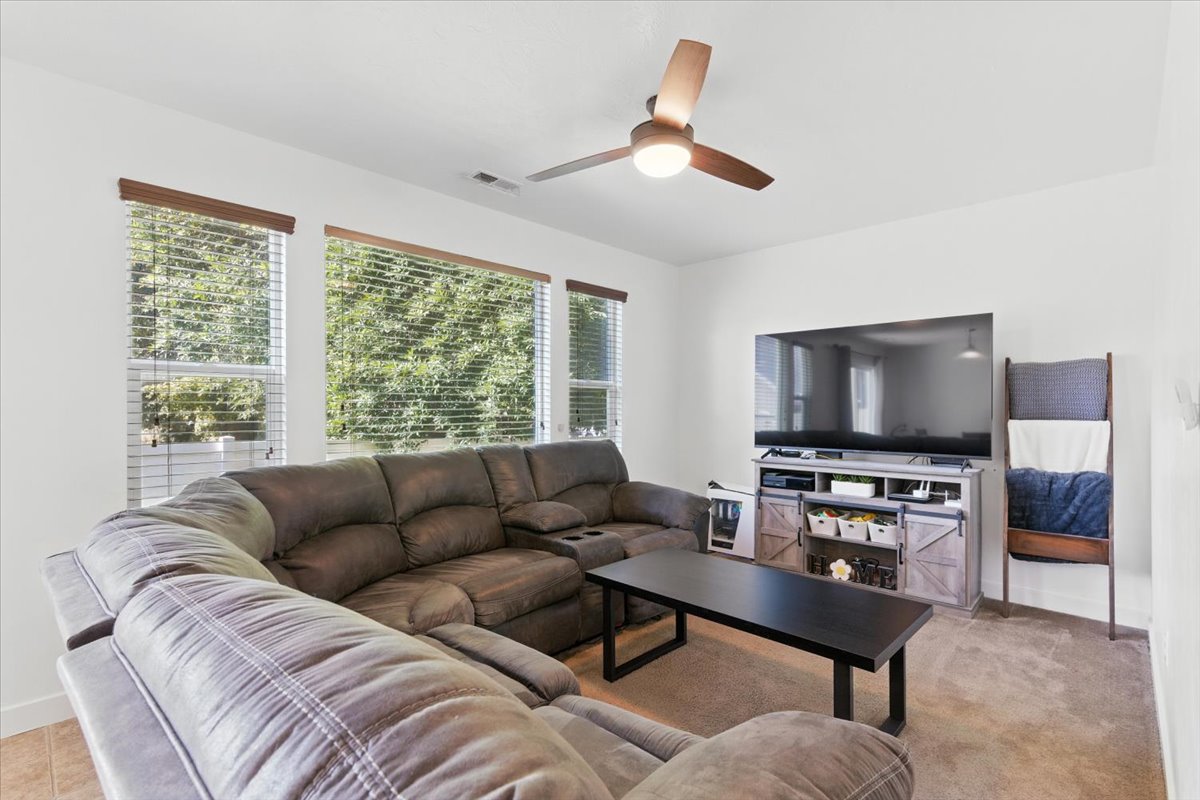 Living room featuring baseboards and a ceiling fan