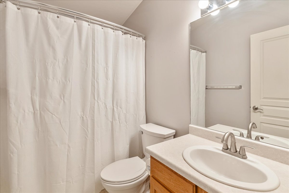 Full bathroom with vanity and a shower with shower curtain