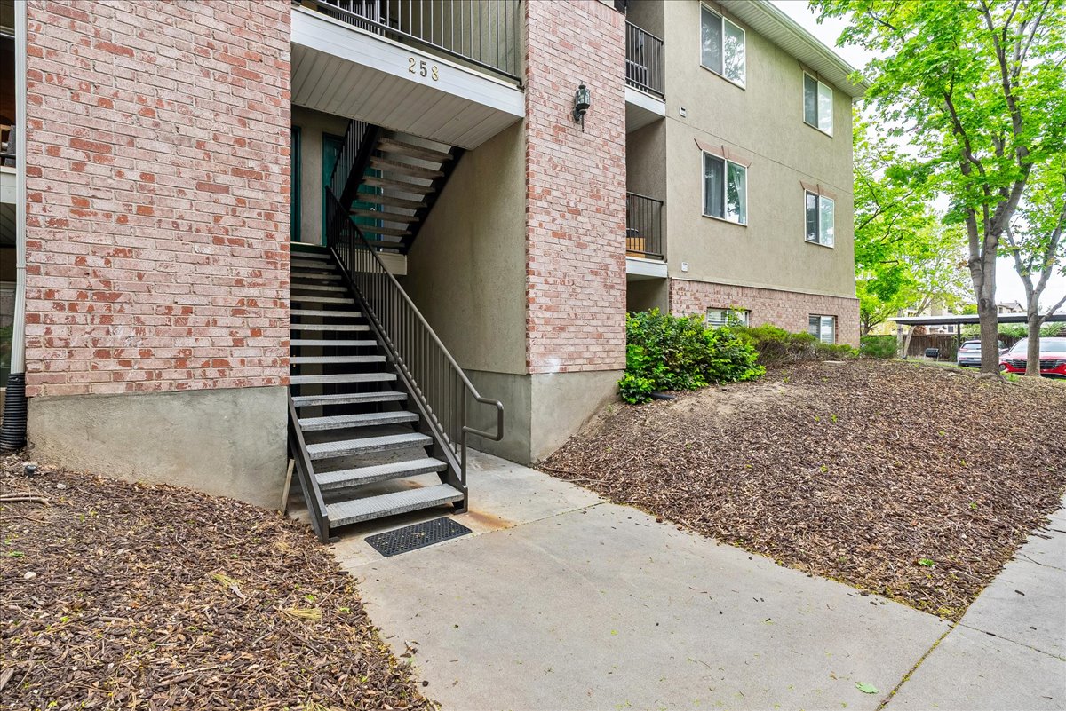 Doorway to property with stucco siding and brick siding