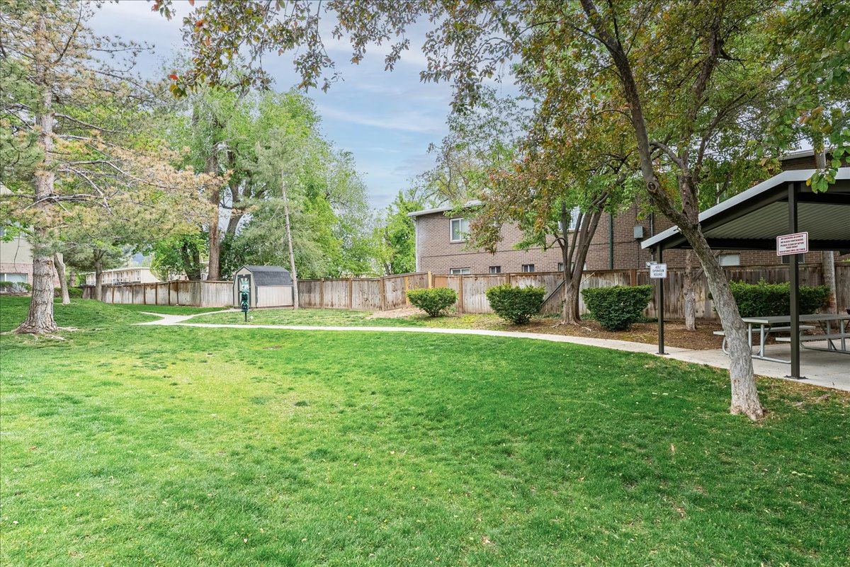 Fenced backyard featuring a shed