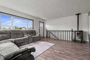 Living area with a wood pellet stove, including the stairs to the basement