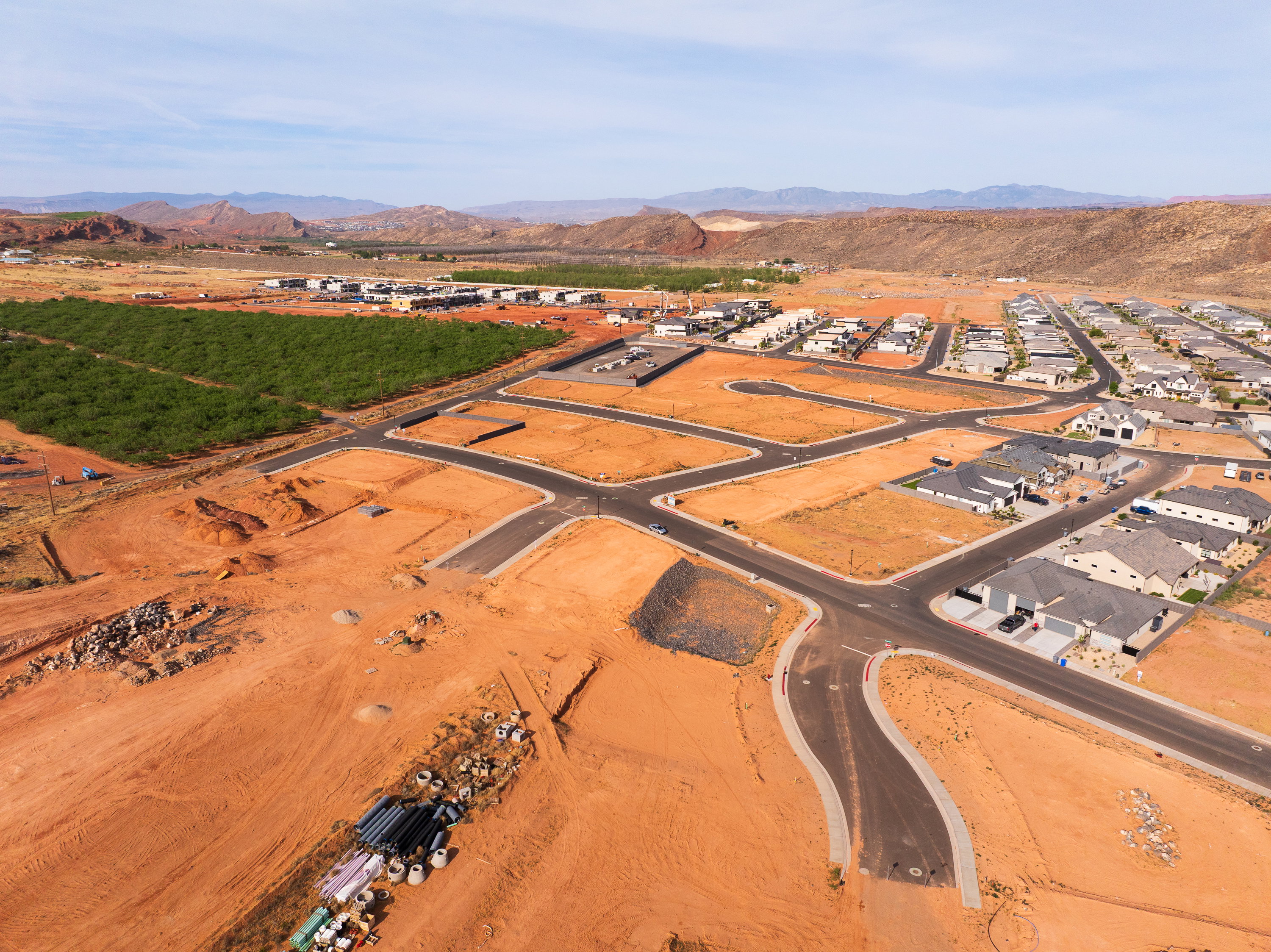 Aerial overview of property's location featuring a mountain backdrop and nearby suburban area